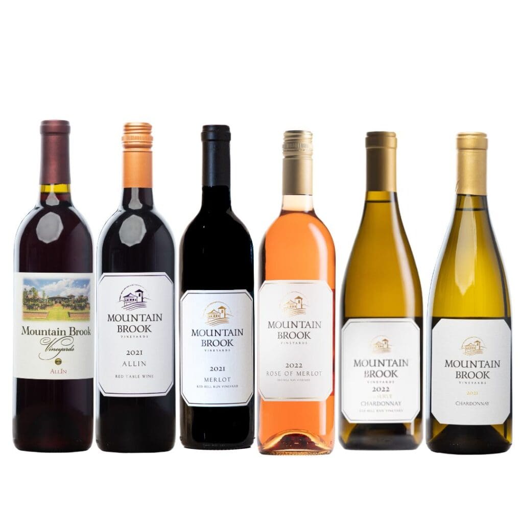 Six bottles of Mountain Brook wine in a row, featuring red, rosé, and white wine varieties.