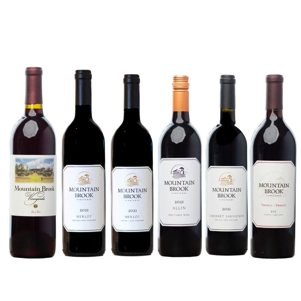 Six bottles of Mountain Brook wine lined up in a row, each with different labels and vintages.